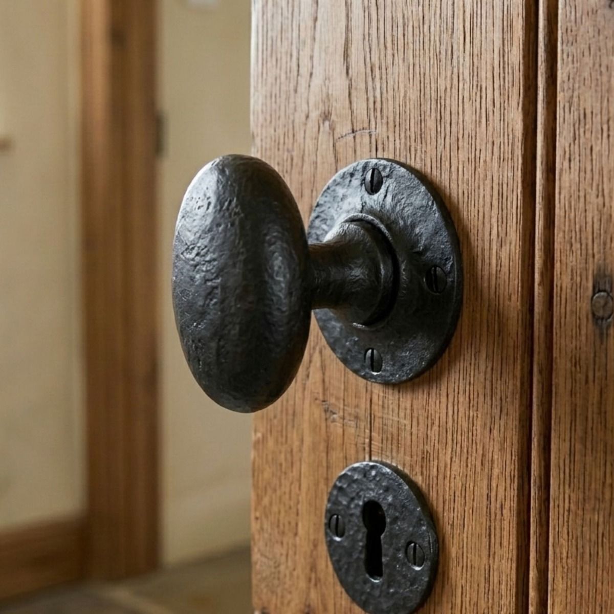 The Beeswax Oval Rim & Mortice Knobs on an Antique Wooden Door in a Home Interior - Digital Illustration
