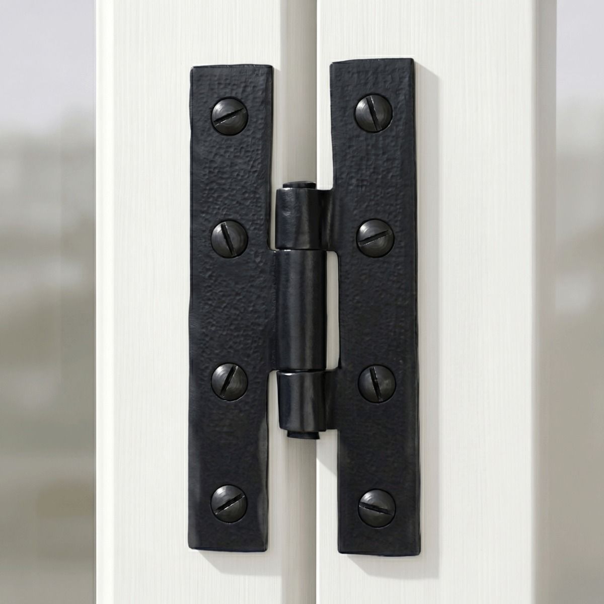 The Black 3¼" Inch H Hinge Pair Mounted on the Inside of a White Wooden Window Frame - Digital Illustration