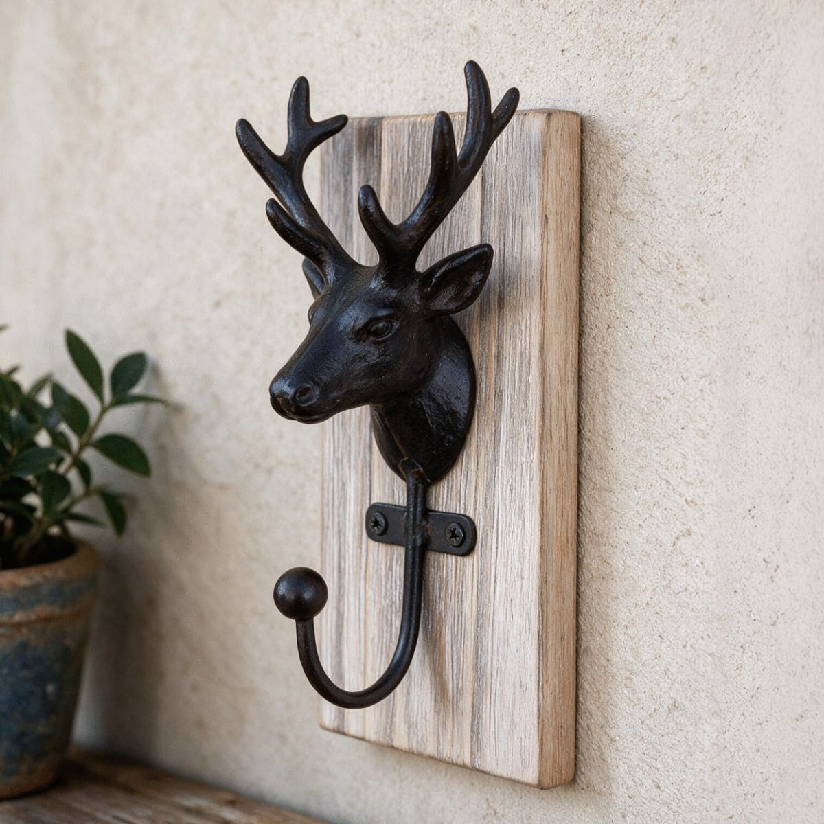 The Black and Natural Wood Stag Coat Hook Mounted on a Textured Wall in a Modern Interior Setting - Digital Illustration