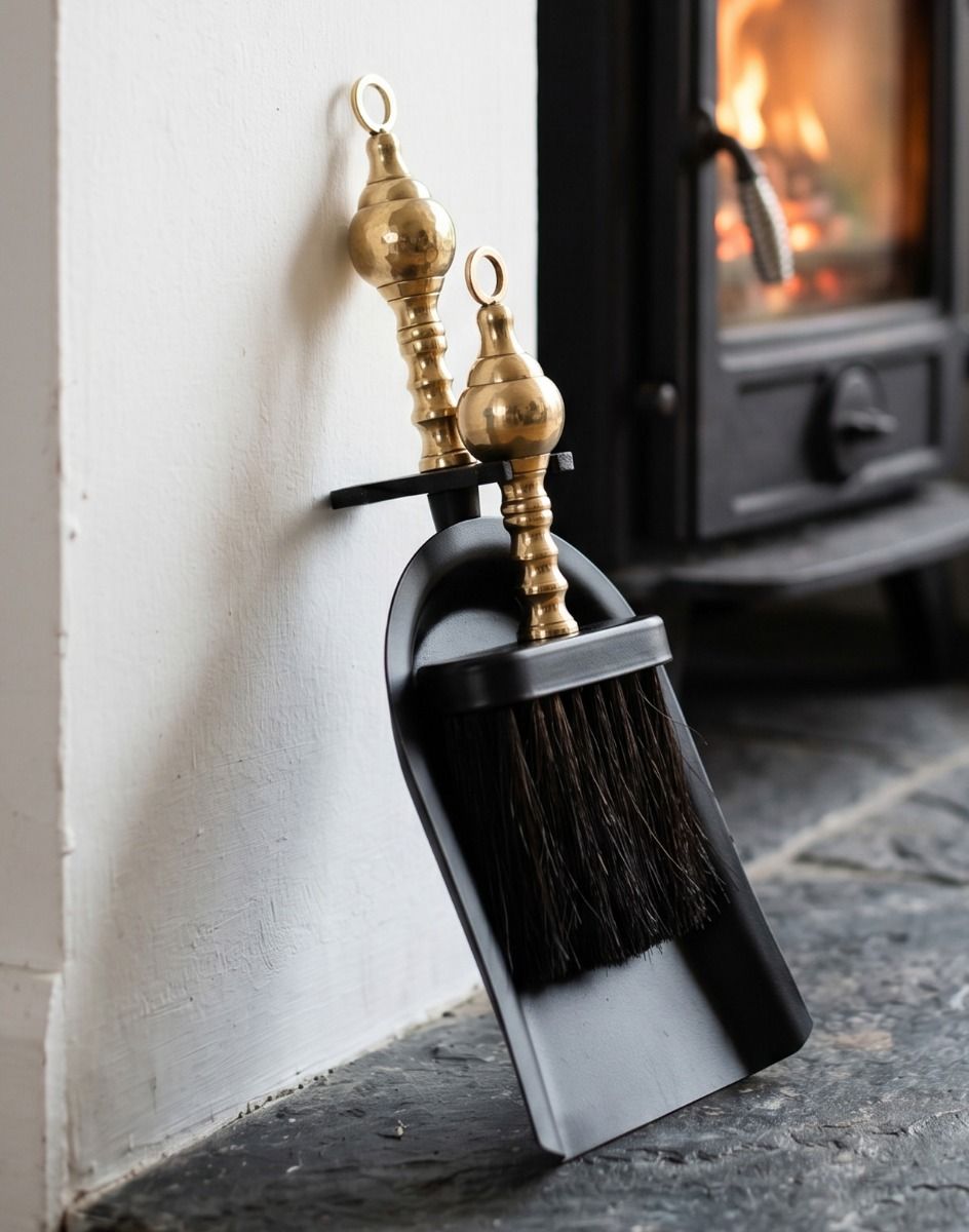 The Black and Polished Brass Pan and Brush Set next to a Traditional Cottage Fireplace - Digital Illustration