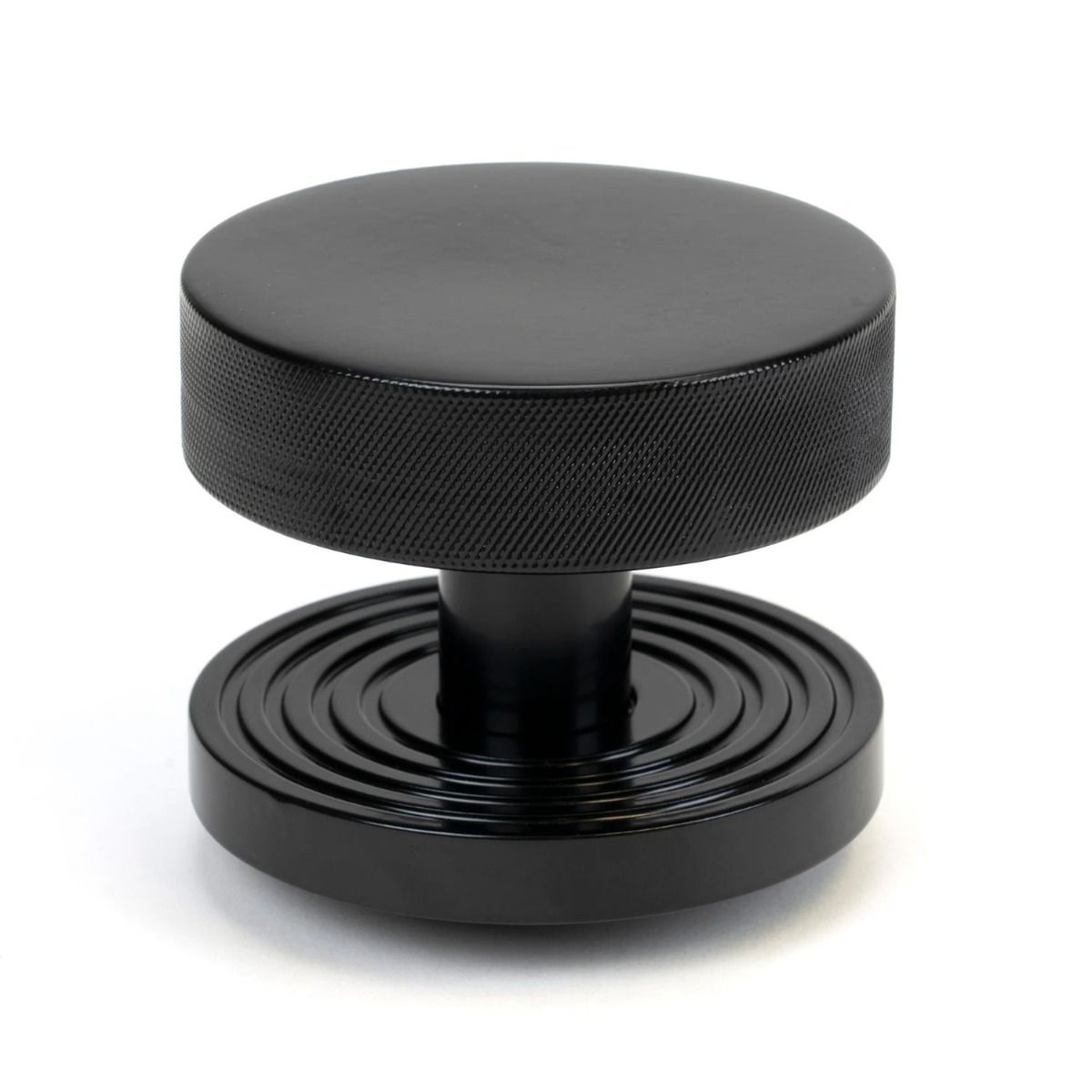 The Black Knurled Centre Door Knob on a Beehive Rose Shown Upright on a White Background 