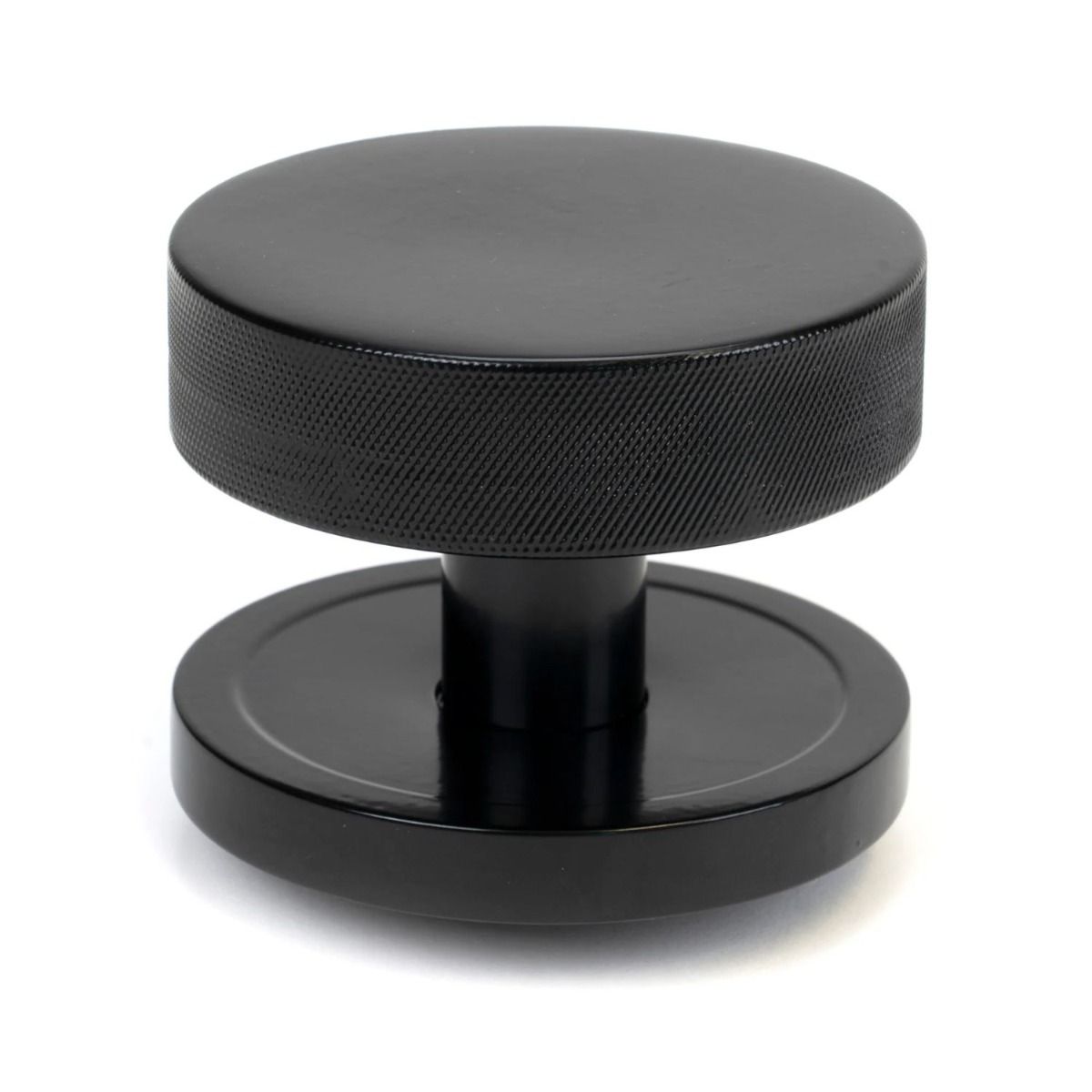 The Black Knurled Centre Door Knob on a Plain Rose Shown Upright on a White Background 