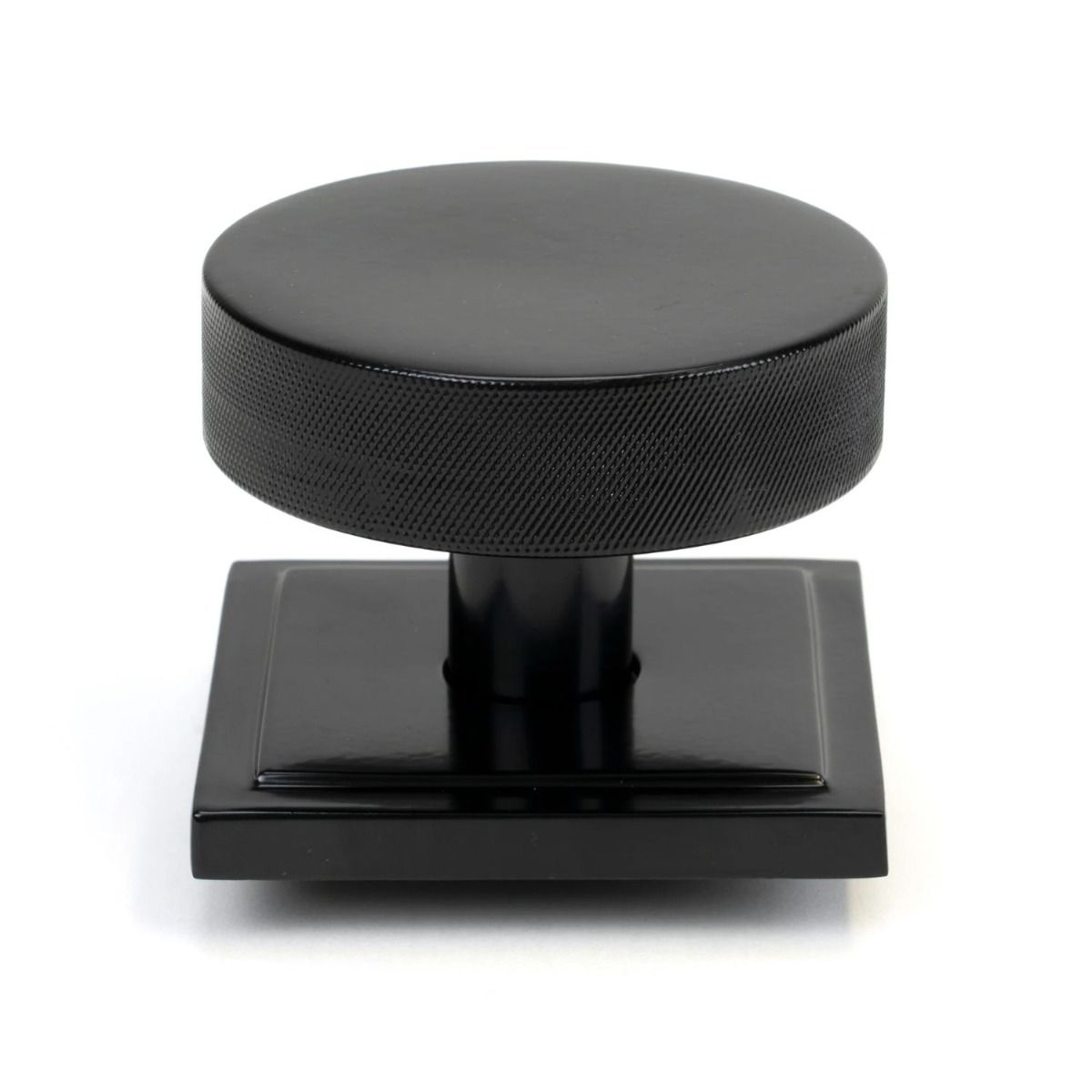 The Black Knurled Centre Door Knob on a Square Rose Shown Upright on a White Background 