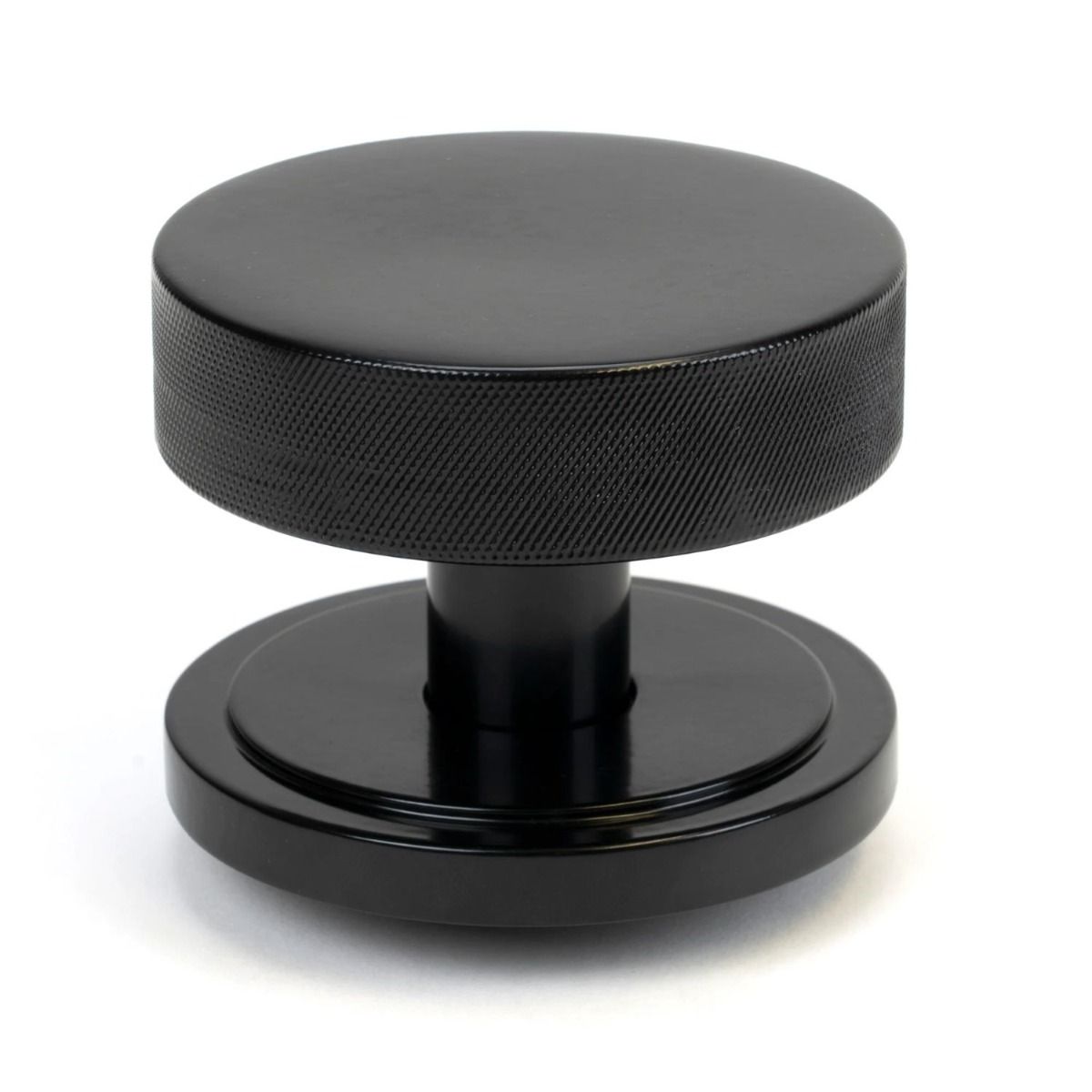 The Black Knurled Centre Door Knob on an Art Deco Rose Shown Upright on a White Background 