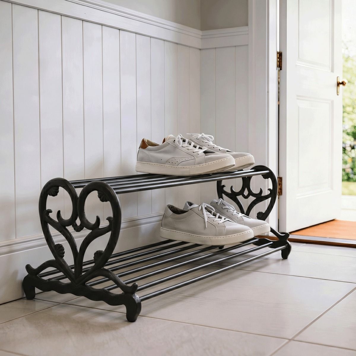The Black “Loredana” Heart Shoe Stand Positioned in a Modern Tiled House Entranceway - Digital Illustration 