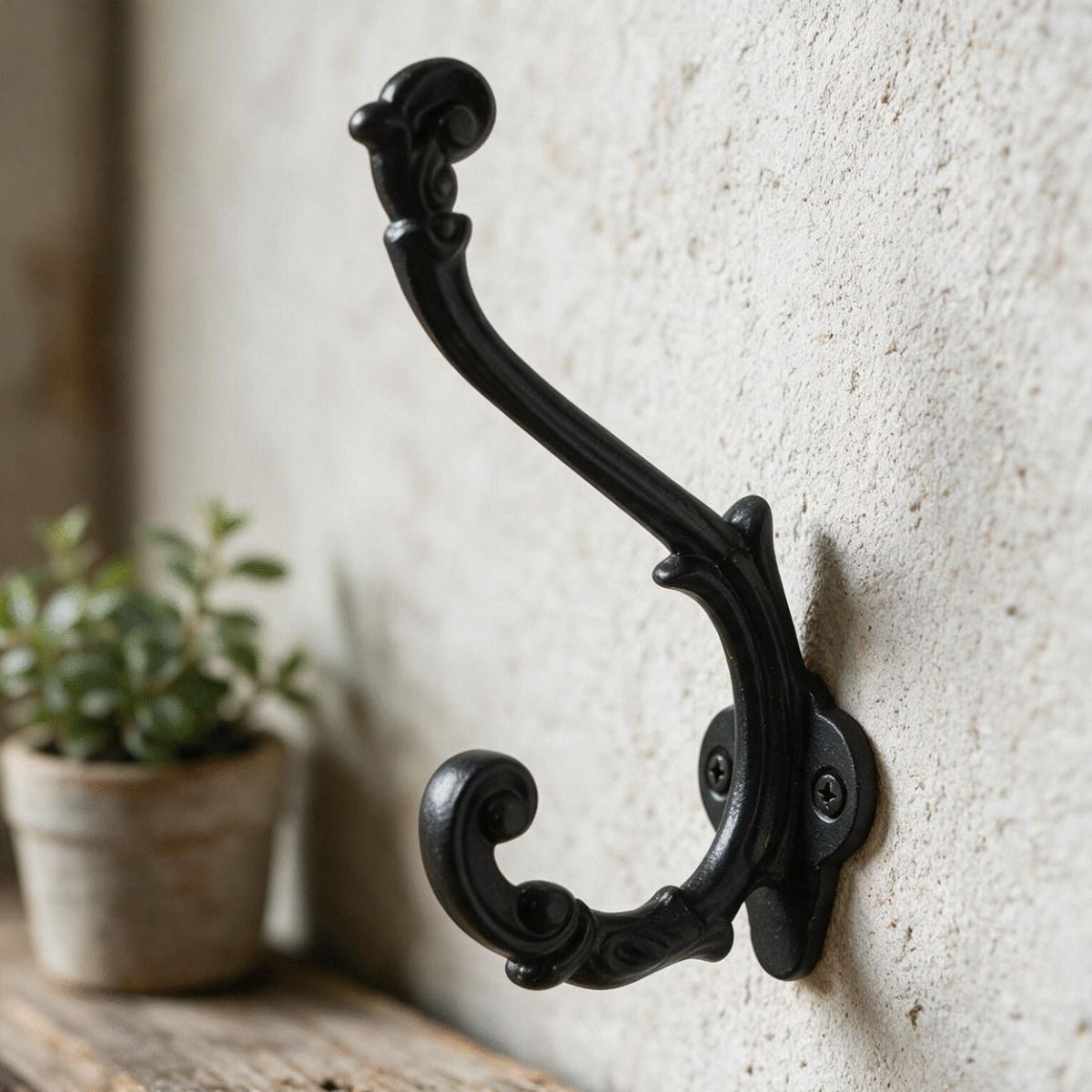 The Black Ornate Scroll Coat Hook Fitted on a Wall in a Traditional Home - Digital Illustration 