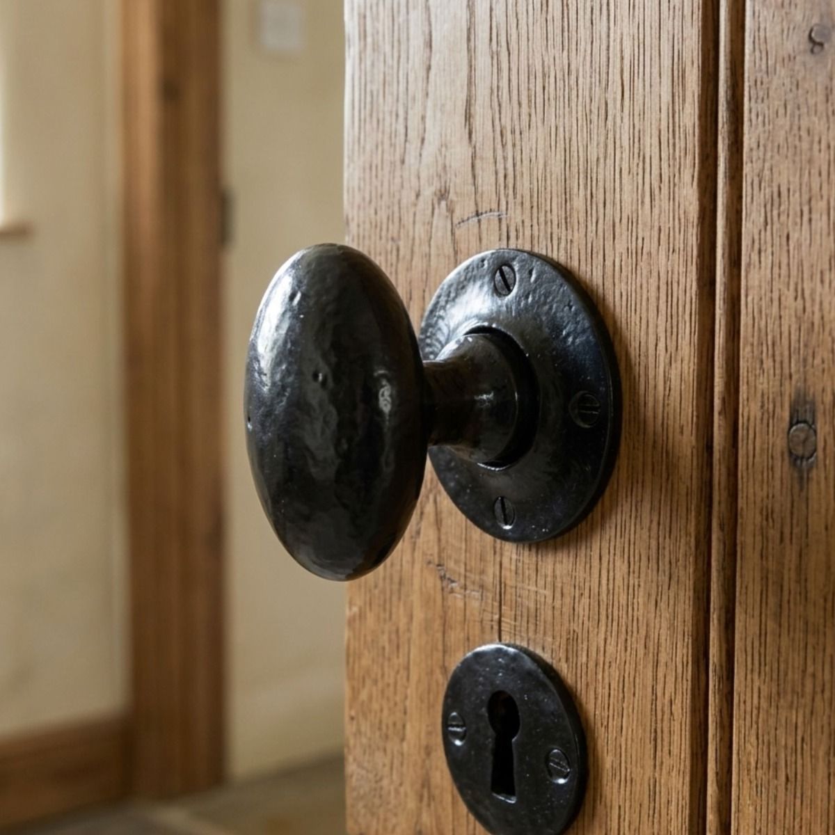 The Black Oval Rim & Mortice Knobs on a Door in a Cream Cottage Interior - Digital Illustration 