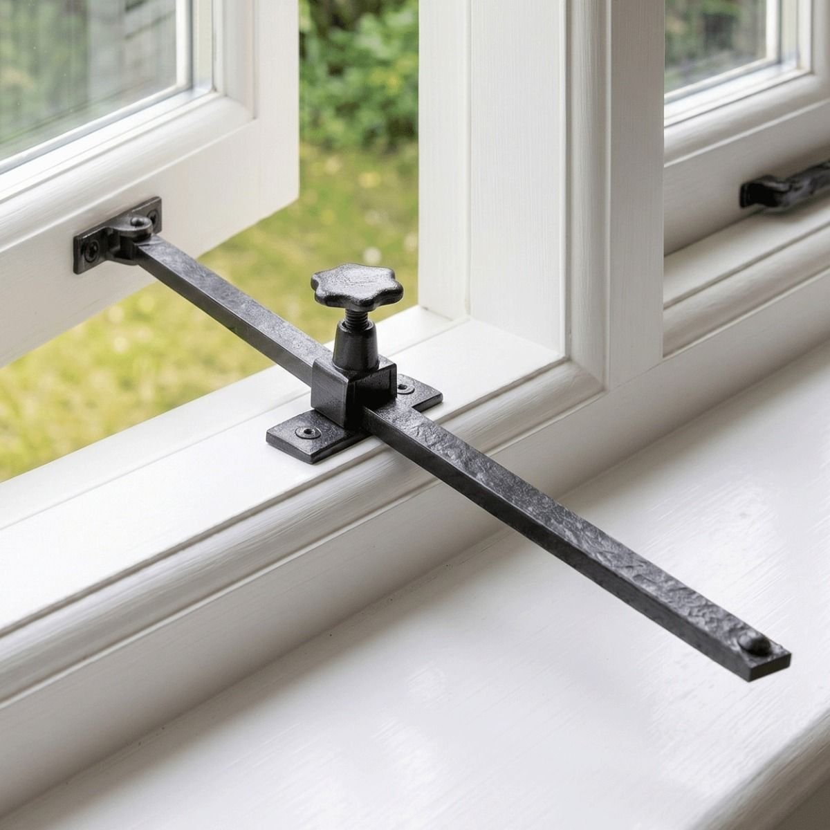 The Black Screw Adjusted Casement Stay Fitted on a White Window Frame - Digital Illustration