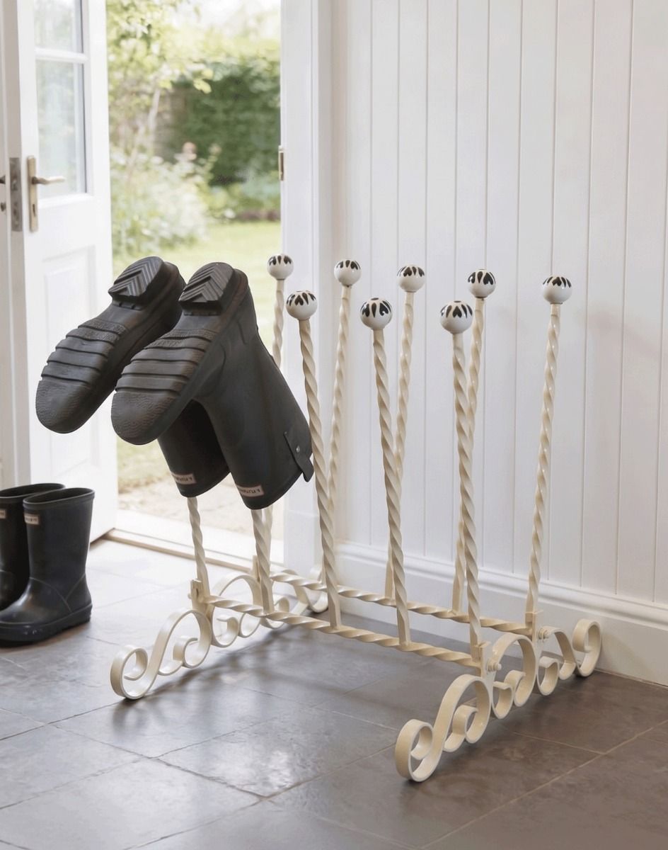 The Bramthatch Wrought Iron 5 Pair Boot Rack Placed next to a Stone Tiled Kitchen Back Door