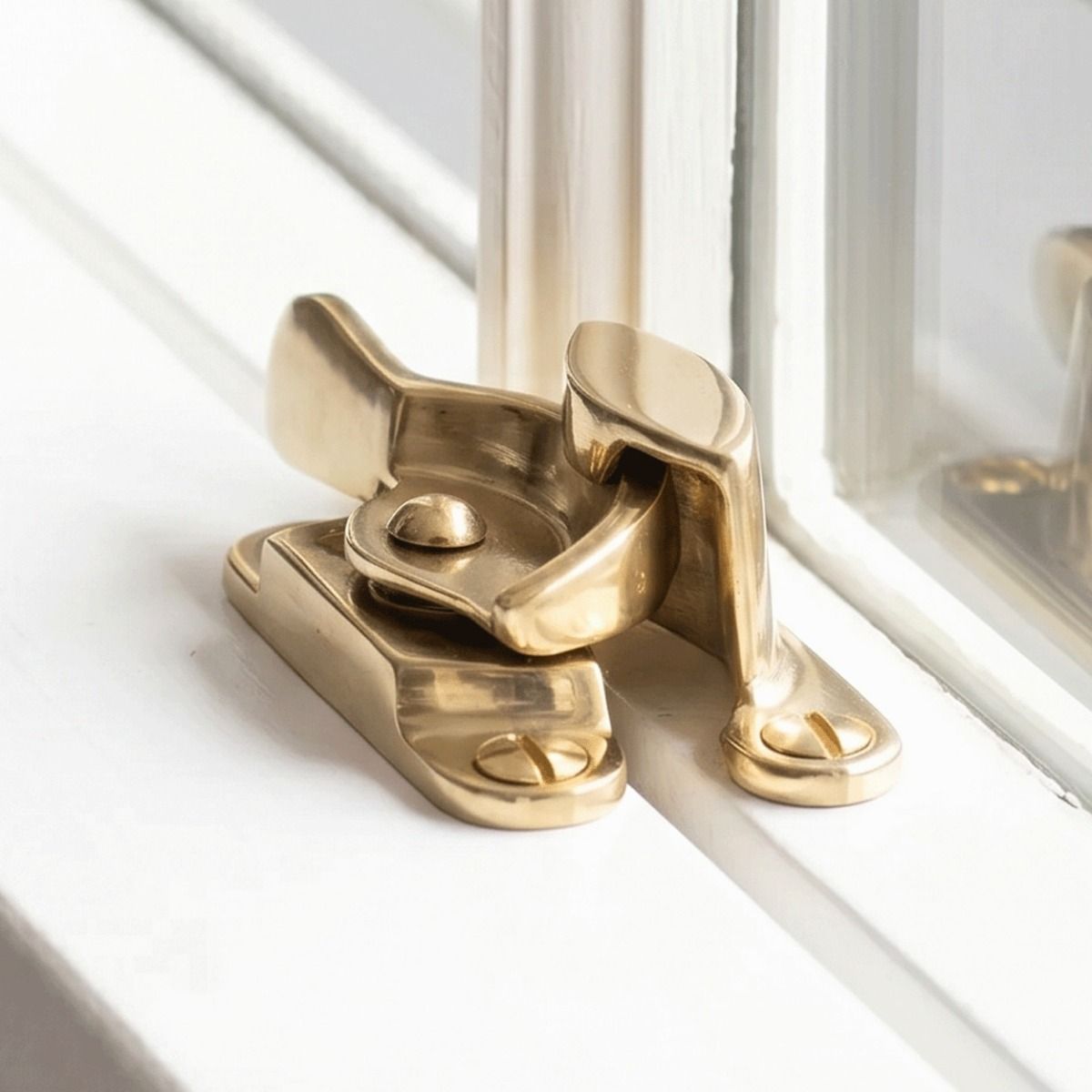 The Brass Fitch Sash Window Fastener Shown Fitted on a Classic White Home Window - Digital Illustration 