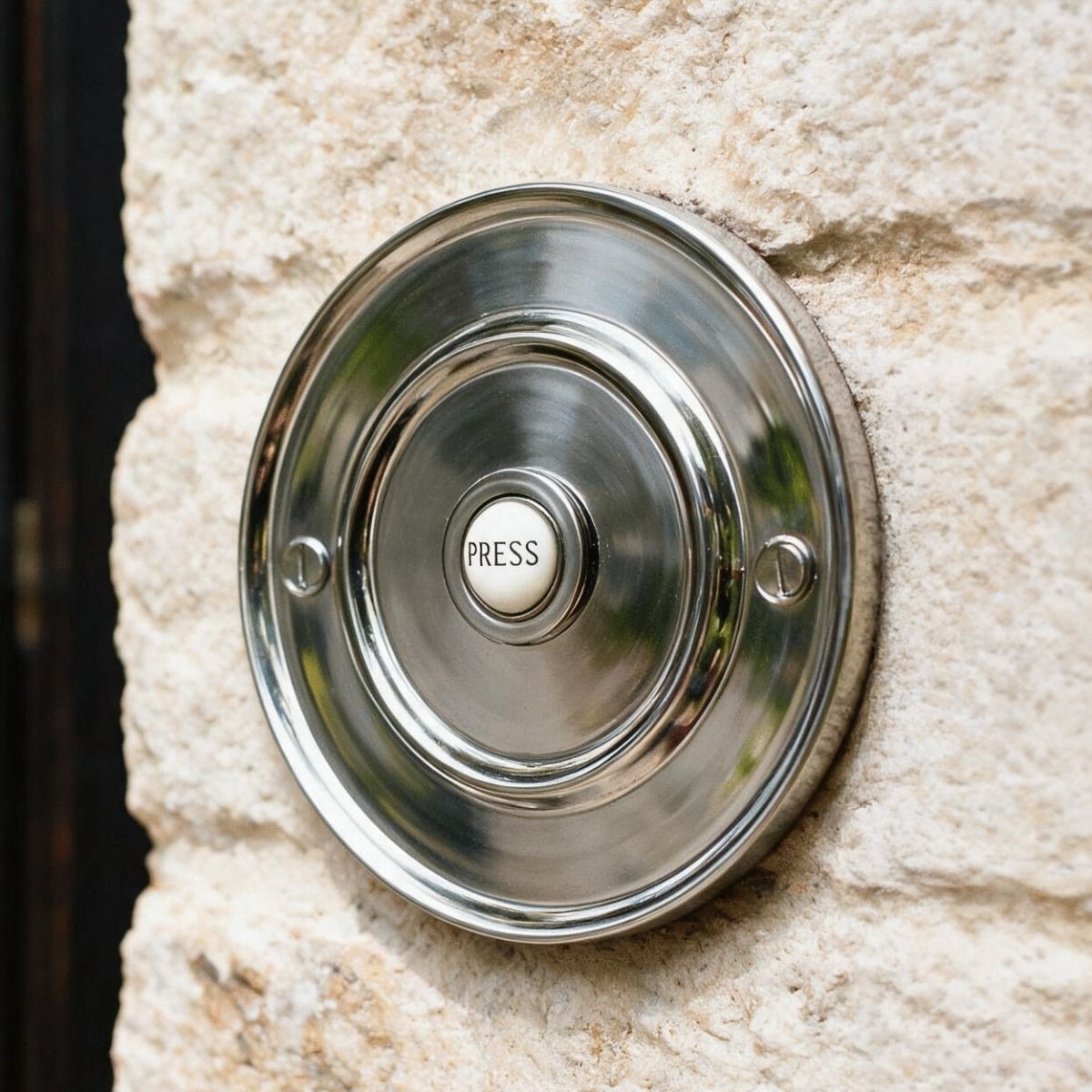 The Bright Chrome Sovereign Park Classic bell push on a Stone Wall of a Traditional Home - Digital Illustration