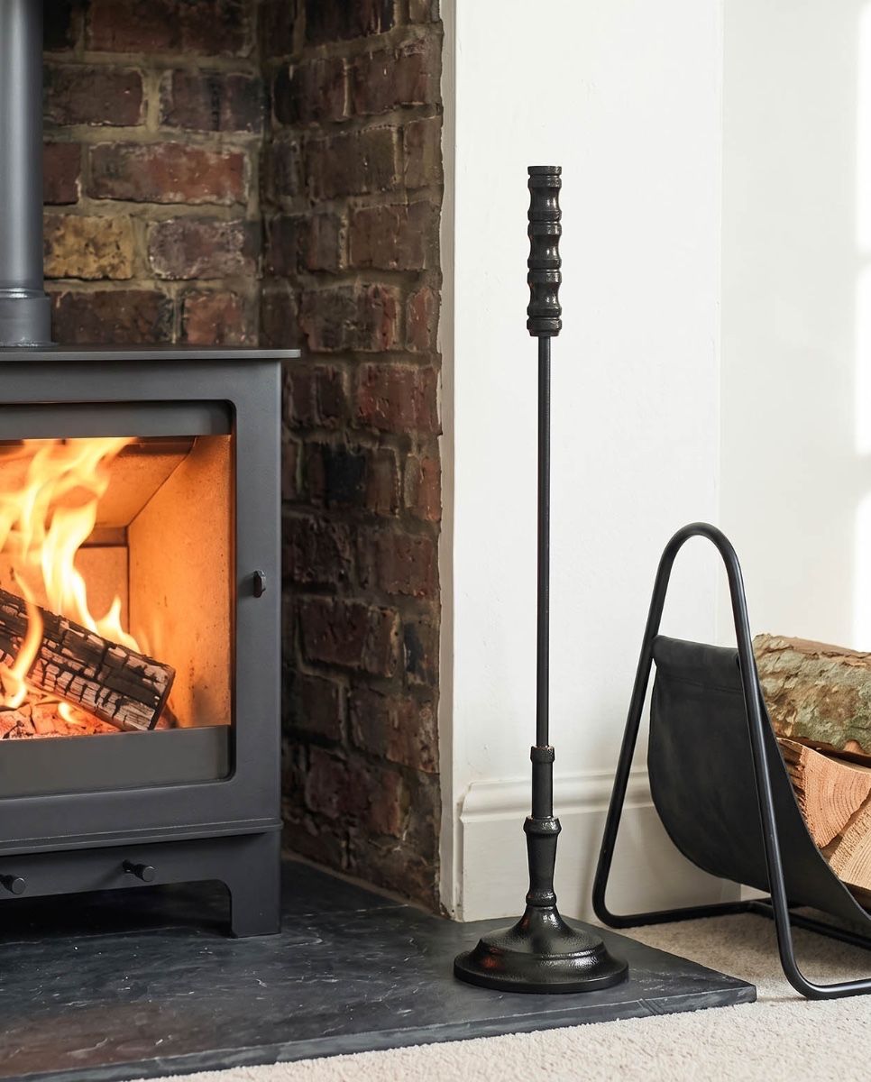 The Calibre Fireside Poker on a Decorative Fireplace next to a Lit Log Burner - Digital Illustration 