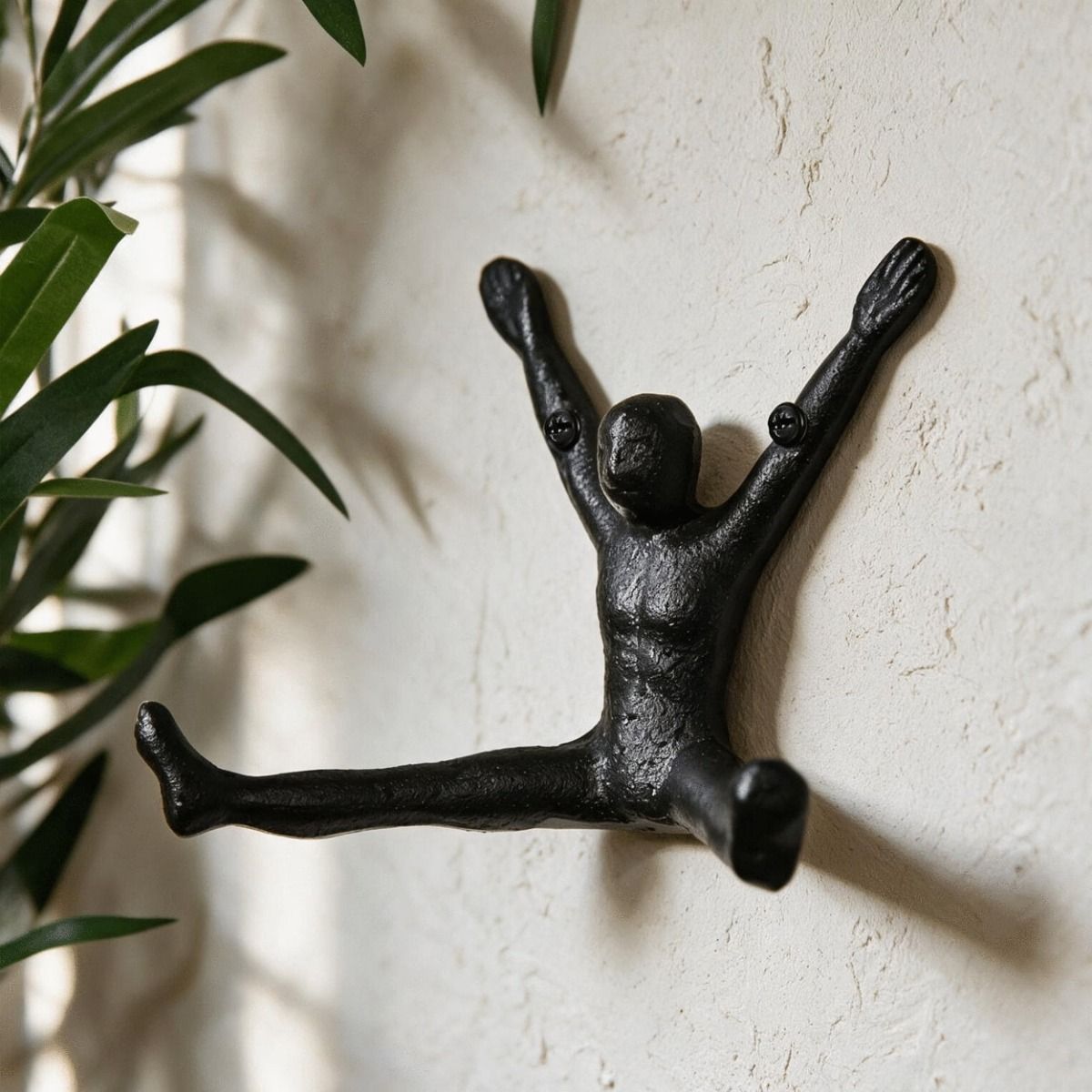 The Cast Iron "Star Jump" Coat Hook `Displayed on a Textured Cream Wall - Digital Illustration