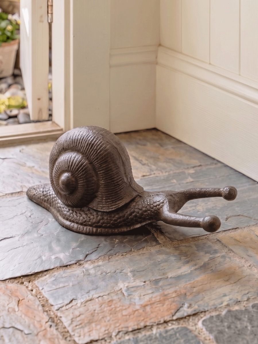 The Cast iron snail Boot Jack on a Traditional Stone Tile Porch Floor - Digital Illustration 