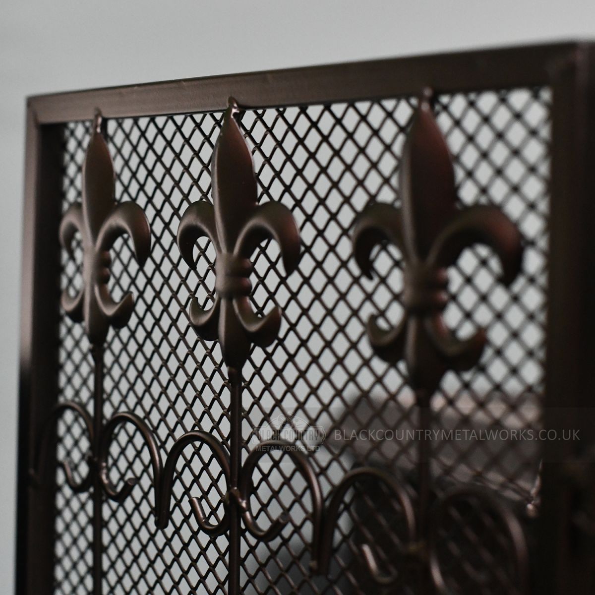 Close-up of the Fleur De Lys Design on the Eing of the Fireguard
