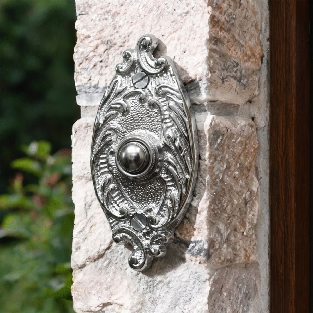 The Clarice Oval Bright Chrome Ornate Bell Push on a Country Cottage Exterior Wall - Digital Illustration