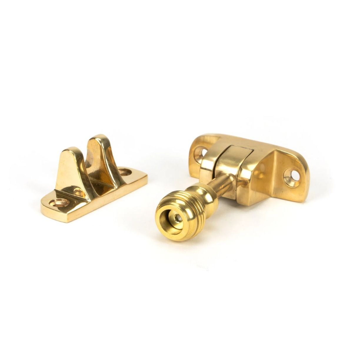 The Classic Reeded Brighton Sash Window Fastener in Polished Brass on a White Background 