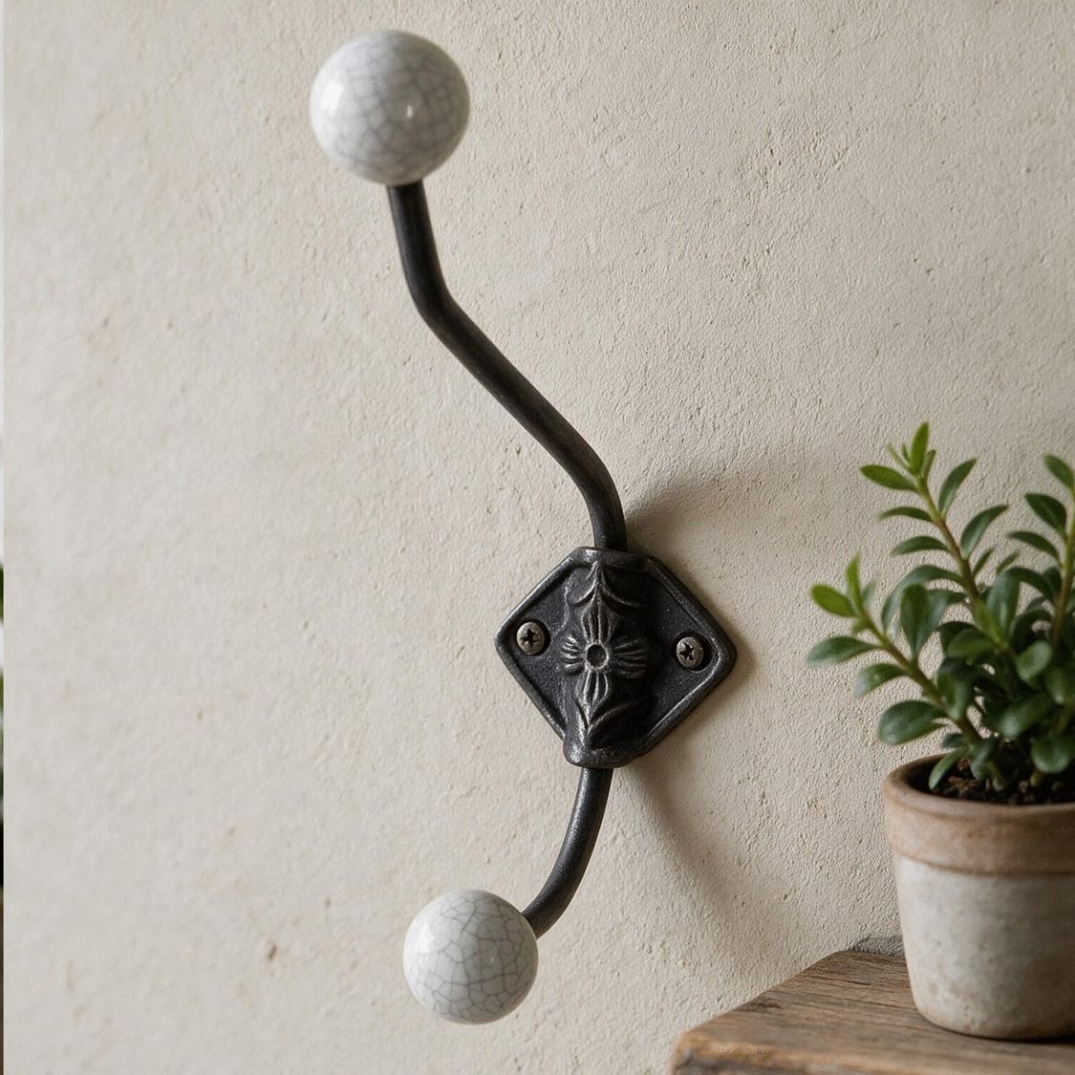 The Crackled Ceramic Tip Large Iron Coat Hook Fitted on an Interior wall next to a Shelf - Digital Illustration