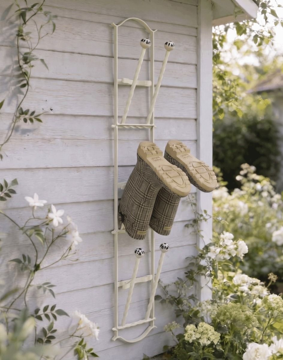The Cream Lingfield Park 3 Pair Wall Mounted Boot Rack Mounted on a Wooden Exterior Wall - Digital Illustration