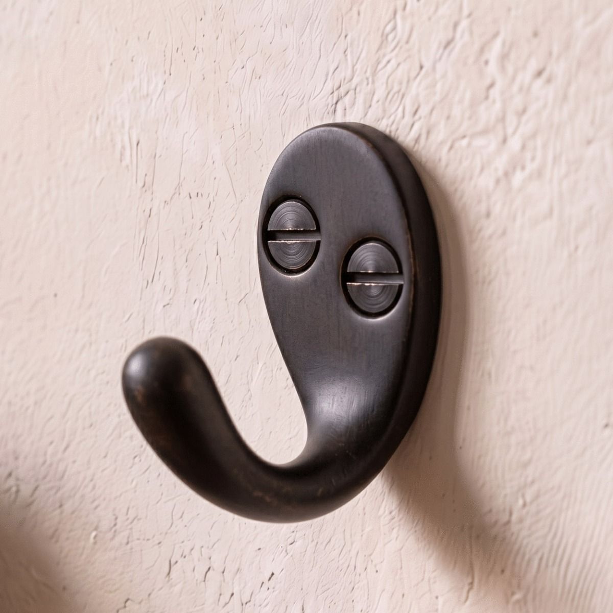 The Dark Aged Bronze Single Pronged Coat Hook on.a Sunny Entrance Hallway Wall - Digital Illustration 