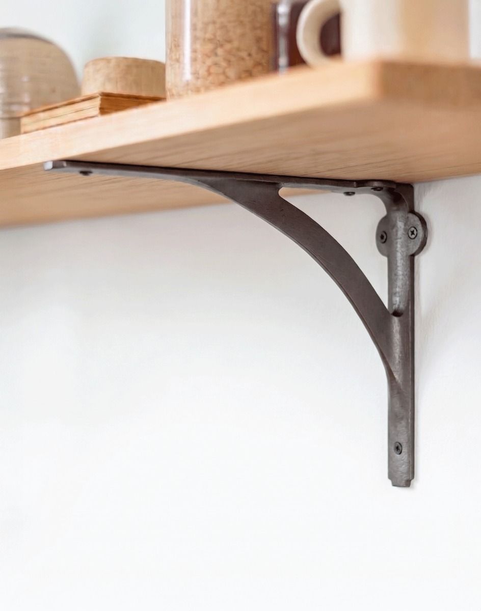 The Decorative Cast Iron Stylish Architectural Shelf Bracket used on a DIY Shelf Mounted on a Modern Interior Wall - Digital Illustration