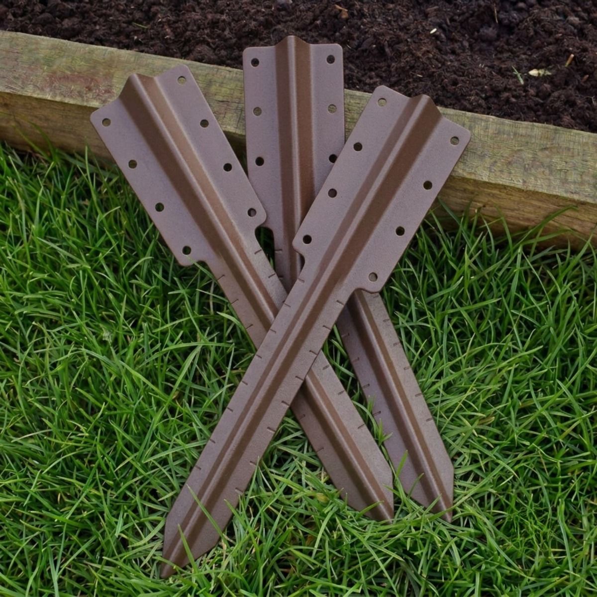 The Double Brown Railway Sleeper Straight Inline Spikes in Brown next to a Raised Flower Bed