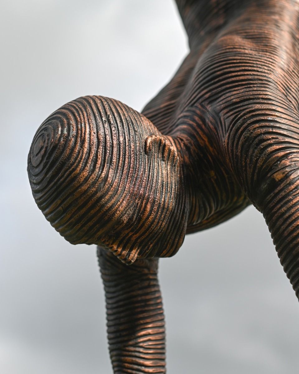 The Equilibrium Handstand Garden Sculpture in Copper Showing a Close up of the Head