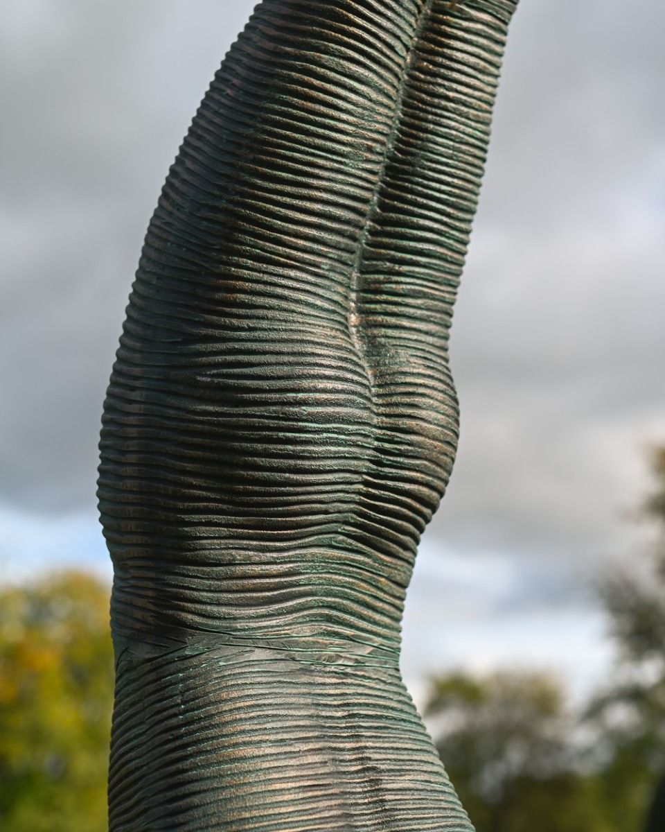 The Equilibrium Handstand Garden Sculpture in Verdigris Showing a Close up of the Head