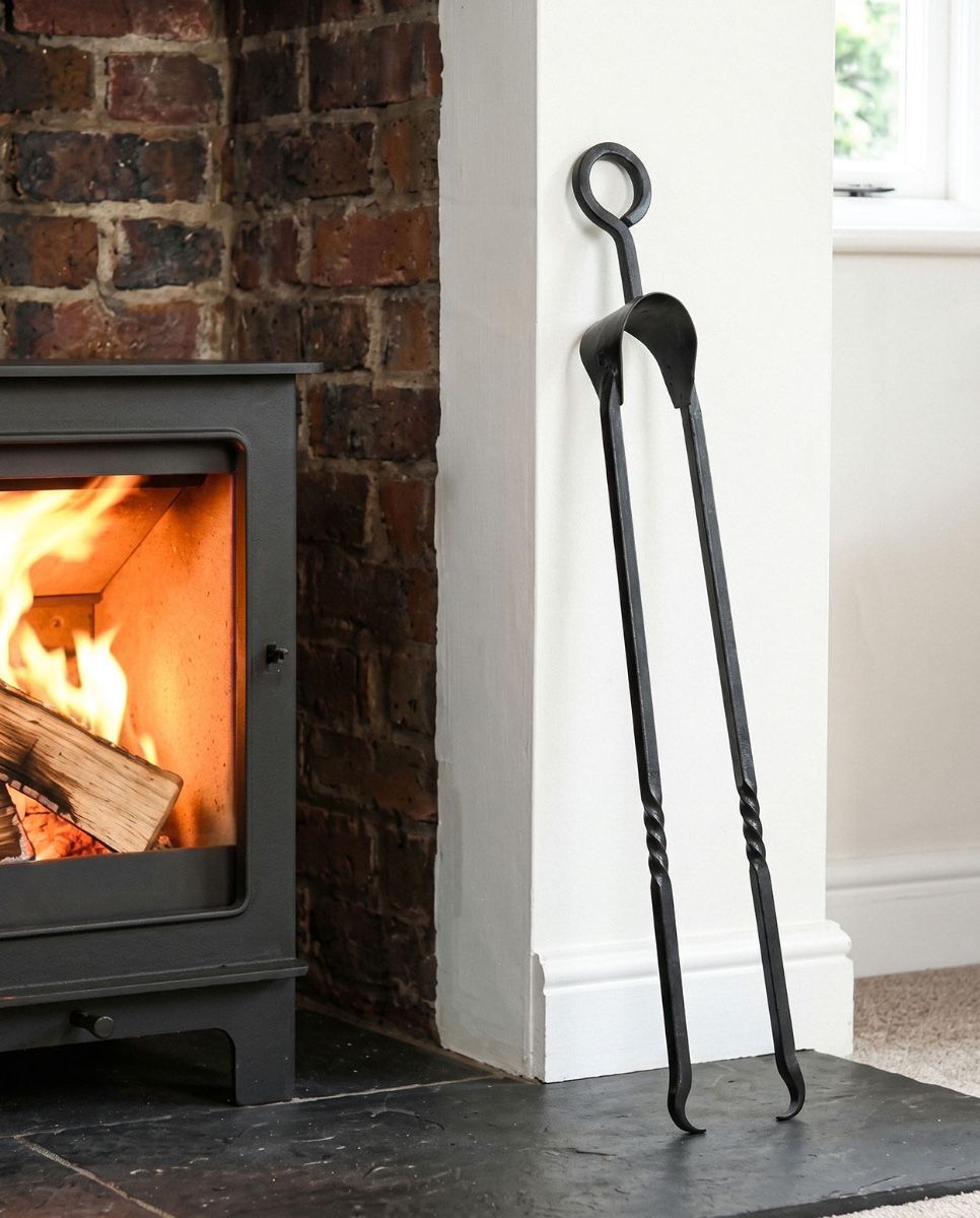 The Extra Long "Sajama" Natural Iron Twist Fireplace Tongs Leaned up Against a Log Basket - Digital Illustration