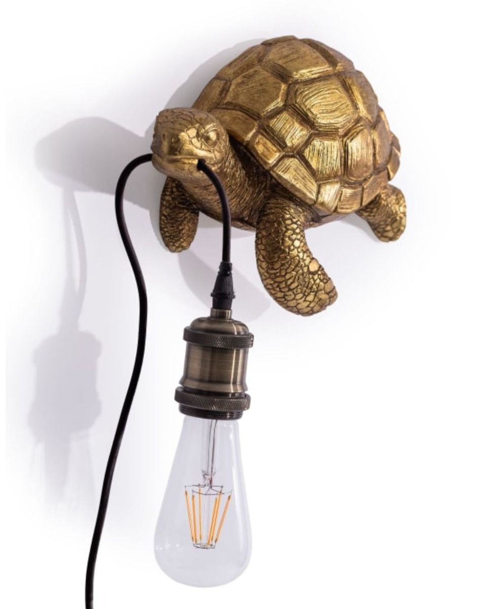The Golden "Oceanic Guide" Turtle Wall Light Shown at an Angle on a White Background 