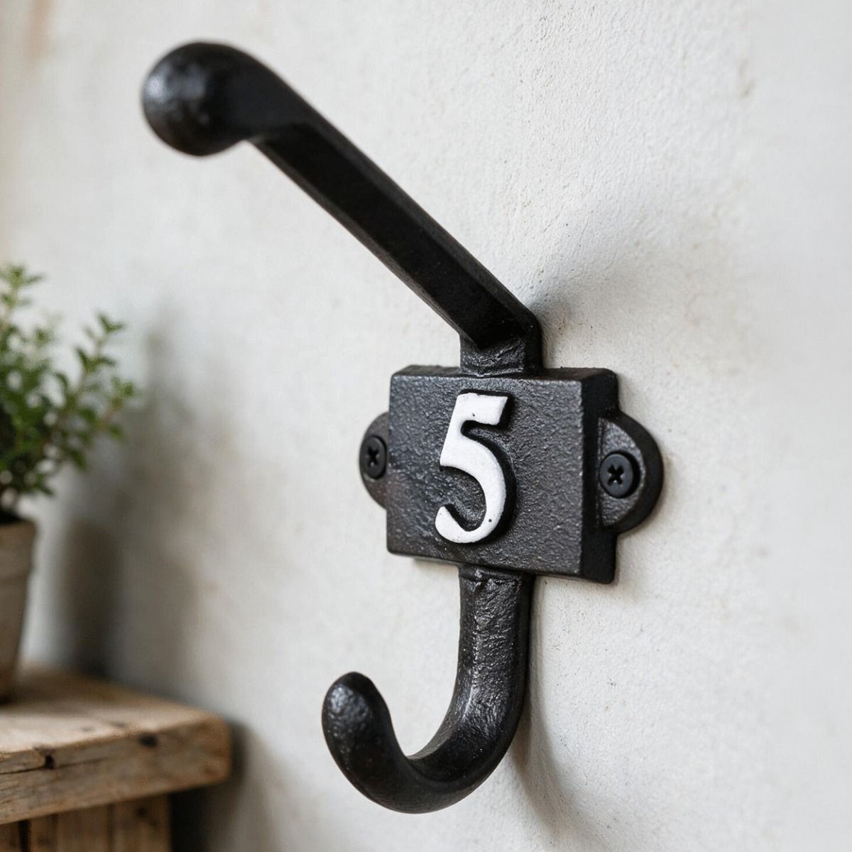 The Iron Coat Hook with Numbe 5 on it Placed Next to a Shelf on an Interior Wall - Digital Illustration