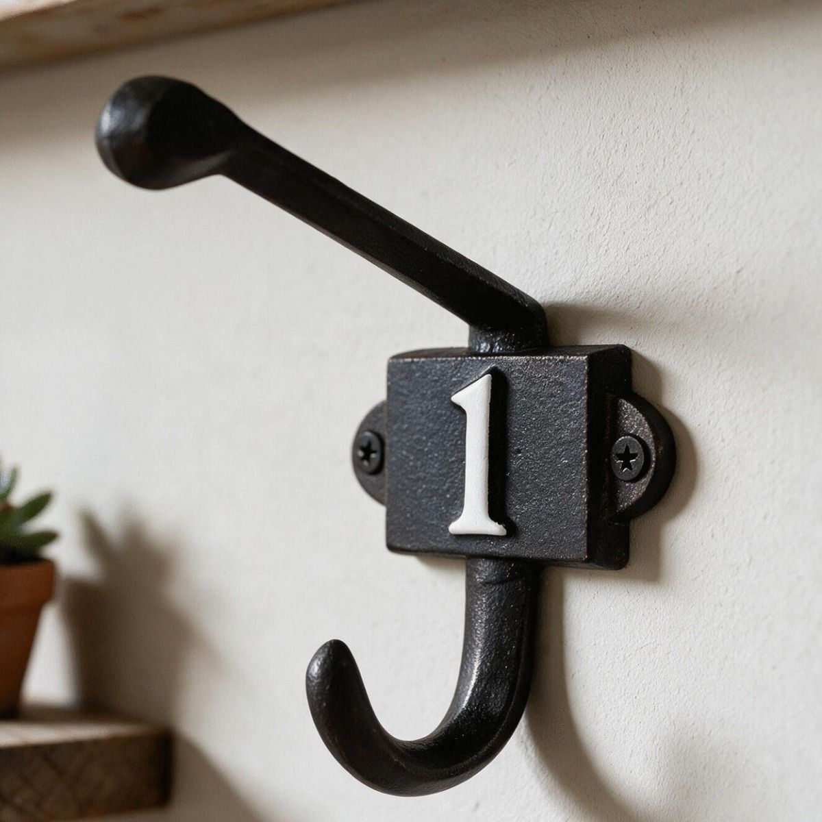 The Iron Coat Hook with the Number 1 Painted on it Shown Mounted on a Wall in a Modern Home - Digital Illustration 