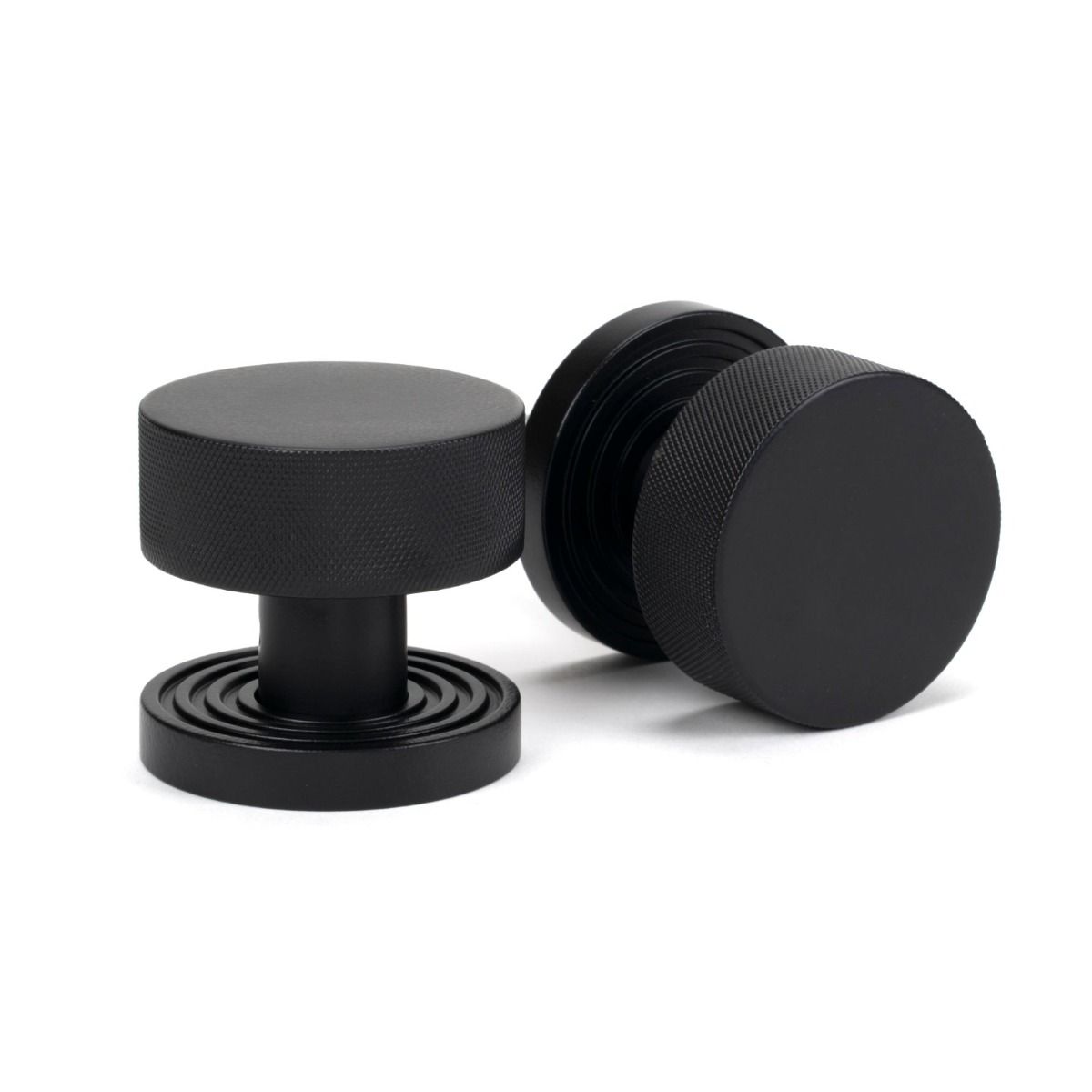 The Knurled Mortice/Rim Knob Set on a Beehive Rose in Matt Black Shown Upright on a White Background 