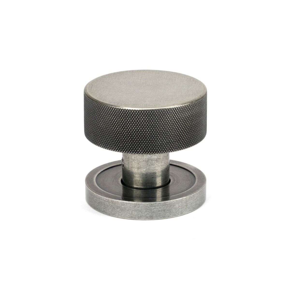 The Knurled Mortice/Rim Knob Set on a Plain Rose in Pewter Shown Upright on a White Background 