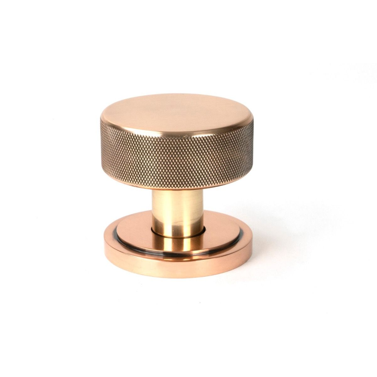 The Knurled Mortice/Rim Knob Set on an Art Deco Rose in Polished Bronze Shown Upright on a White Background 