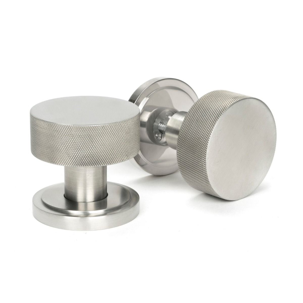 The Knurled Mortice/Rim Knob Set on an Art Deco Rose in Satin Stainless Steel Shown Upright and on its Side 
