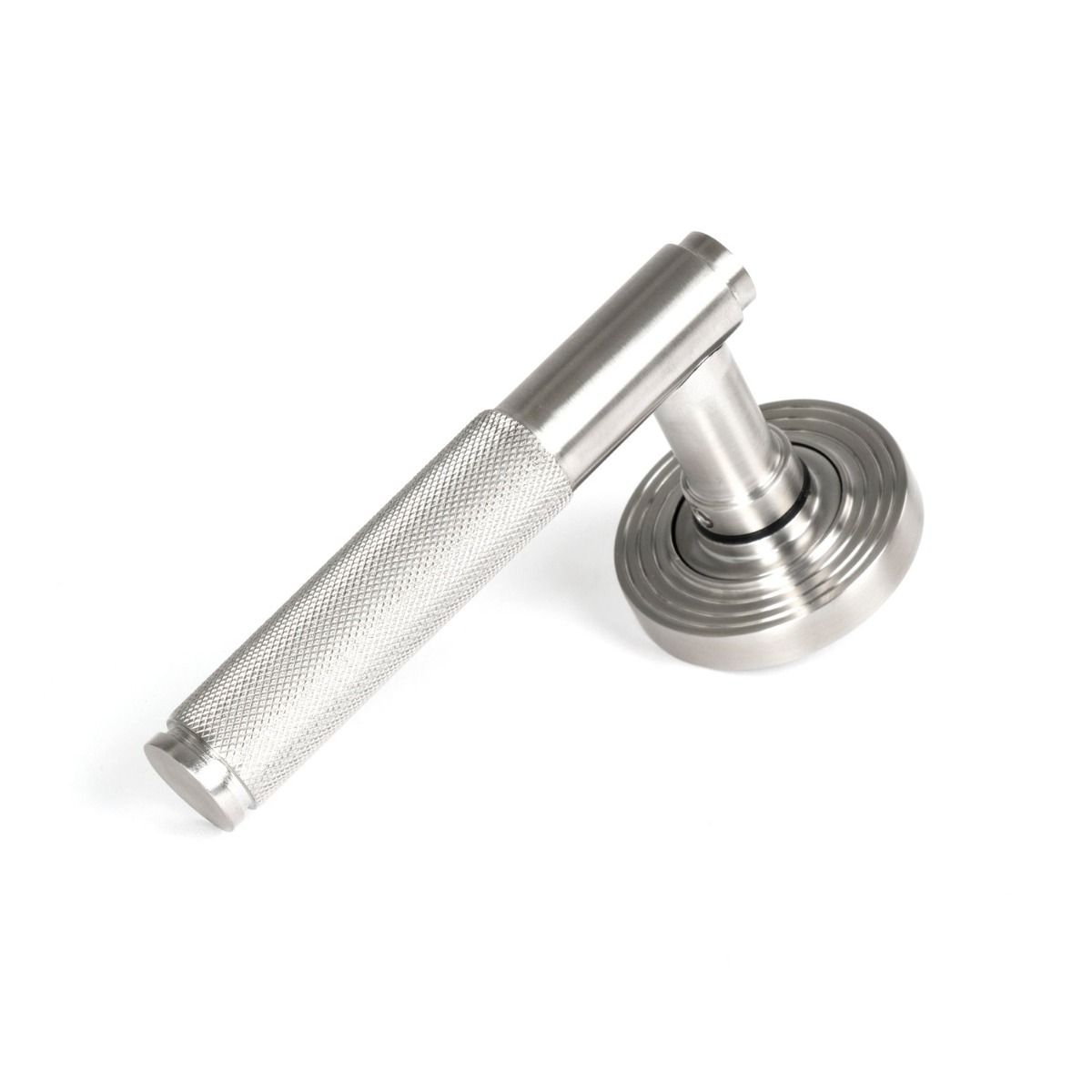 The Knurled Sprung Handle Set on a Beehive Rose in Satin Stainless Steel Shown at an Angle on a White Background
