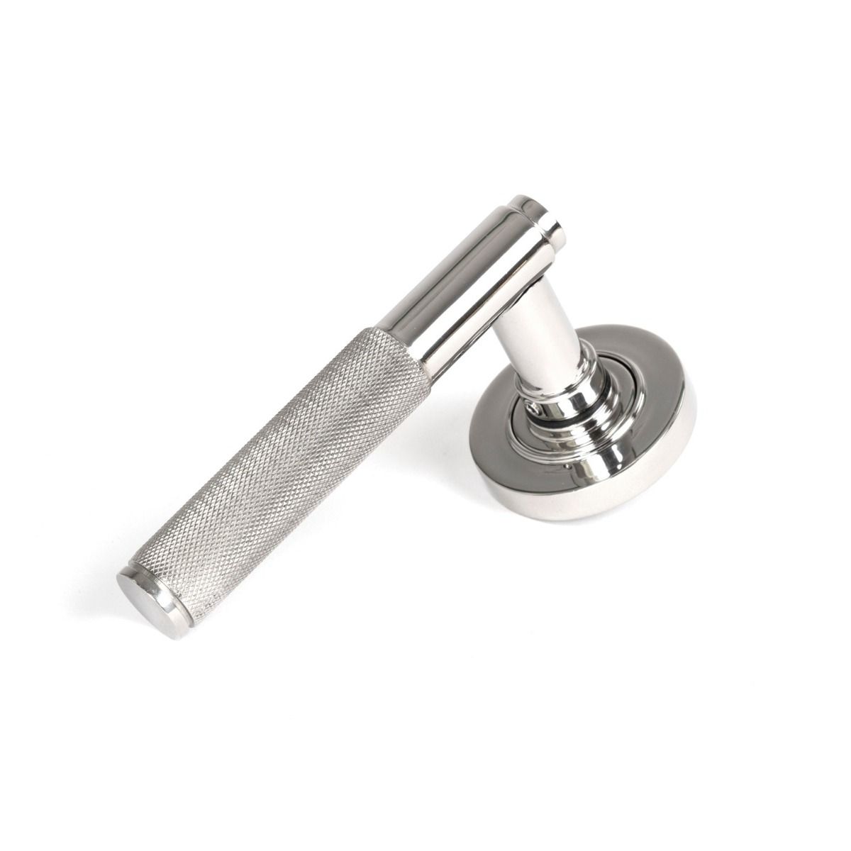 The Knurled Sprung Handle Set on a Round Rose in Polished Stainless Steel Shown at an Angle on a White Background