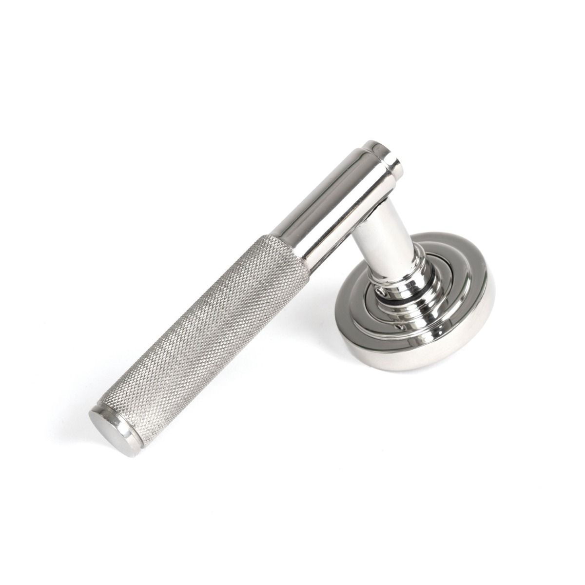 The Knurled Sprung Handle Set on an Art Deco Rose in Polished Stainless Steel Shown at an Angle on a White Background