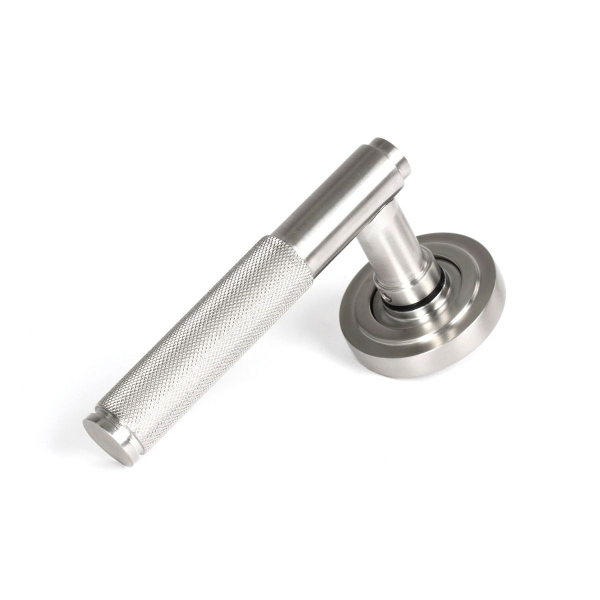 The Knurled Sprung Handle Set on an Art Deco Rose in Satin Stainless Steel Shown at an Angle on a White Background