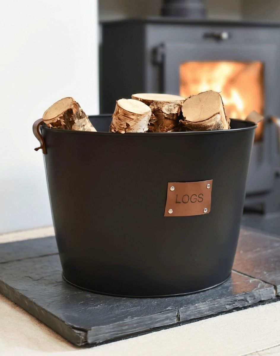 The Large "Logs" Black Log Basket Seen Close up on a Stone Hearth in a Modern Home - Digital Illustration 