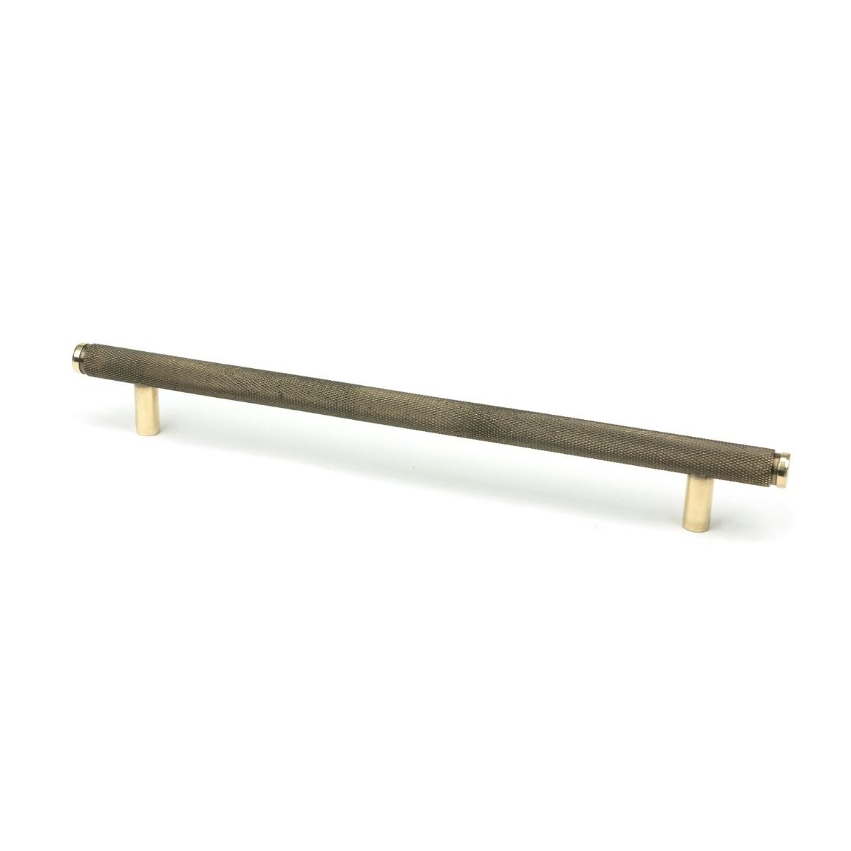 The Large Knurled Cabinet Pull Handle in Aged Brass Shown Upright on a White Background