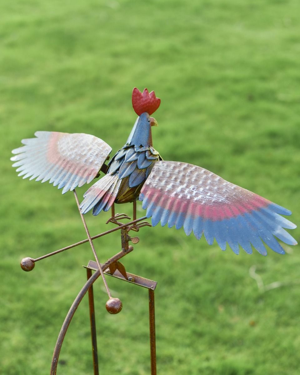 The Large Metal Rooster Rocking Garden Spike Displaying the Coloured Wings from Behind