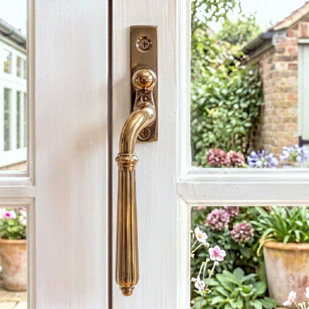 The Left-Handed Polished Bronze Reeded Georgian Espagnolette Window Handle in a Country Home - Digital Illustration 