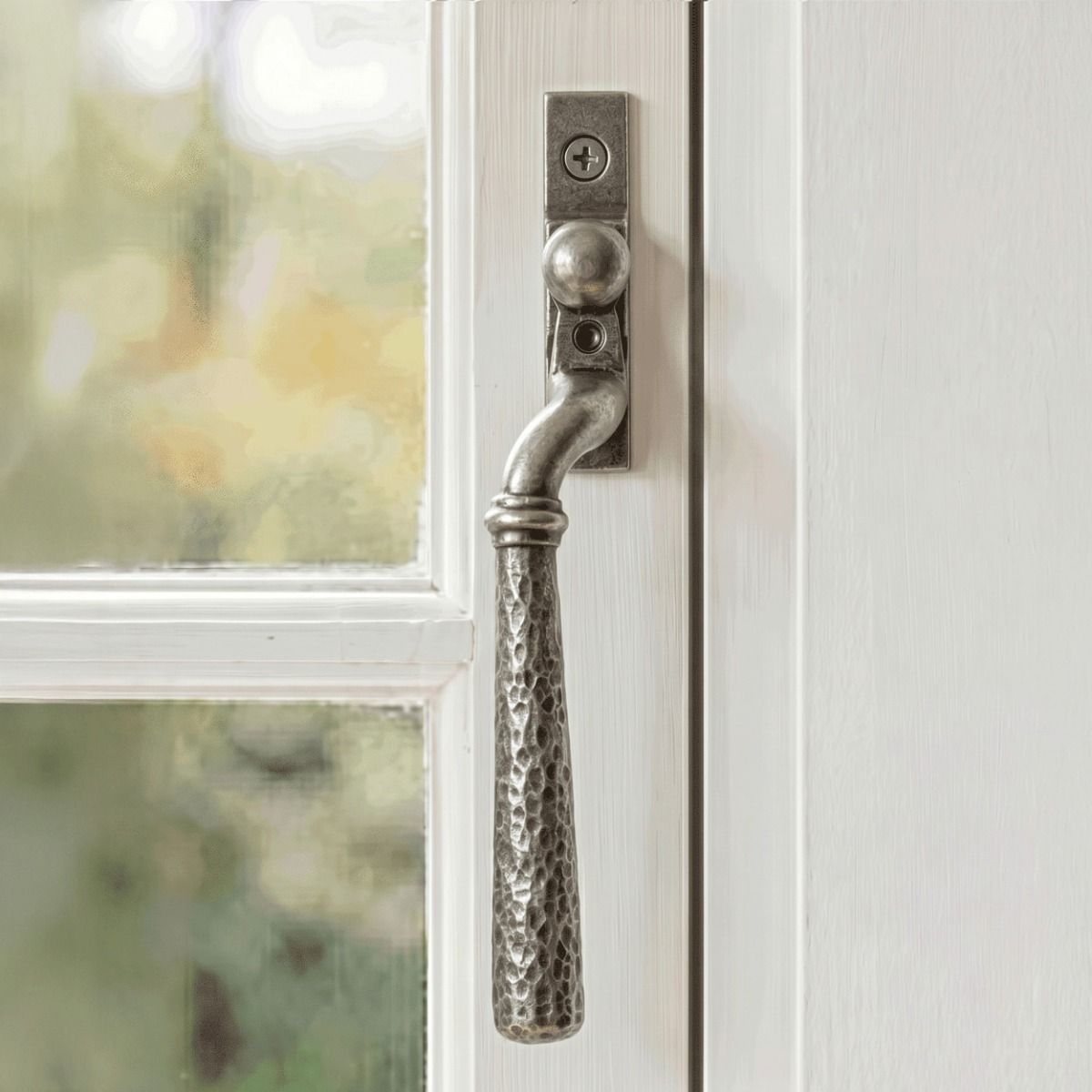 The Right Hand 16mm Hammered Pewter Espagnolette Window Handle on a White Painted Window Frame - Digital Illustration 
