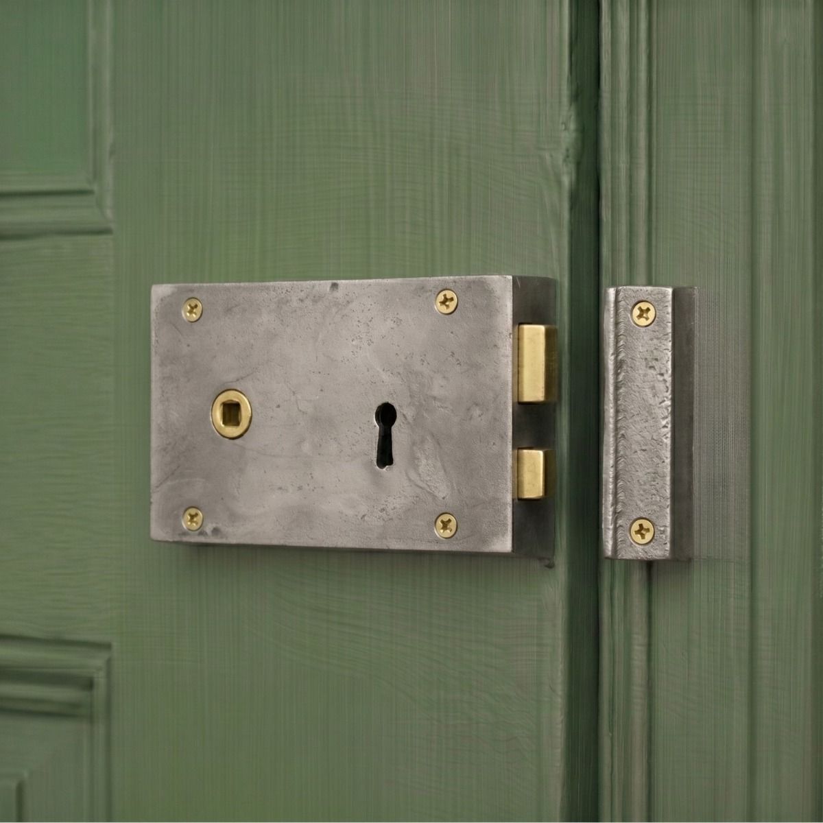 The Left Handed "Olini" Large Iron Rim Lock Securing a Green Wooden Door - Digital Illustration 