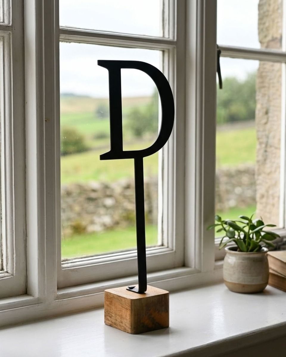 The Letter "D" Monograph Metal & Wood Letter Display Ornament on a White Windowsill - Digital Illustration 