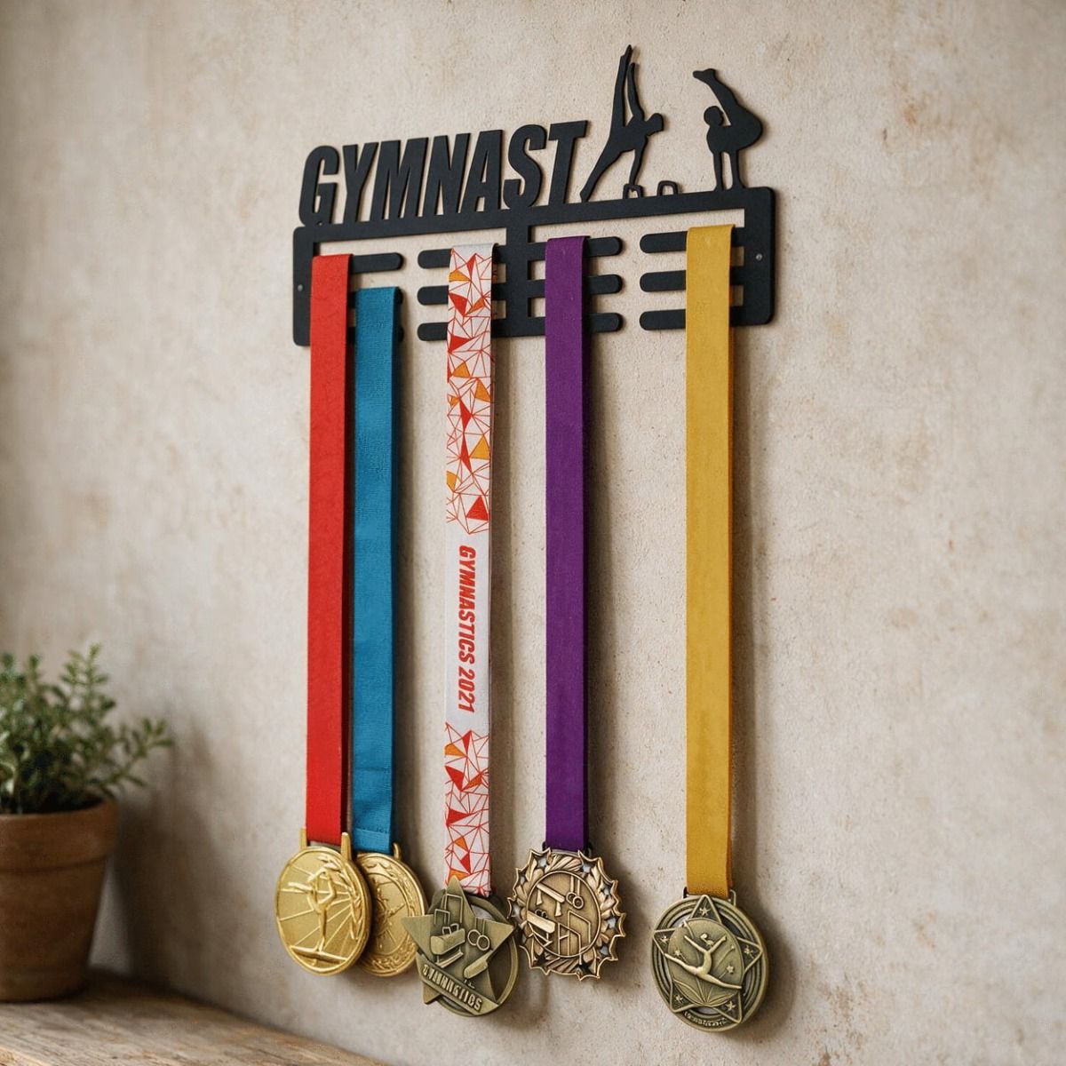 The Male "Gymnast" Sports Medal Hanger with Medals on it Displayed on a Cream Coloured Wall - Digital Illustration