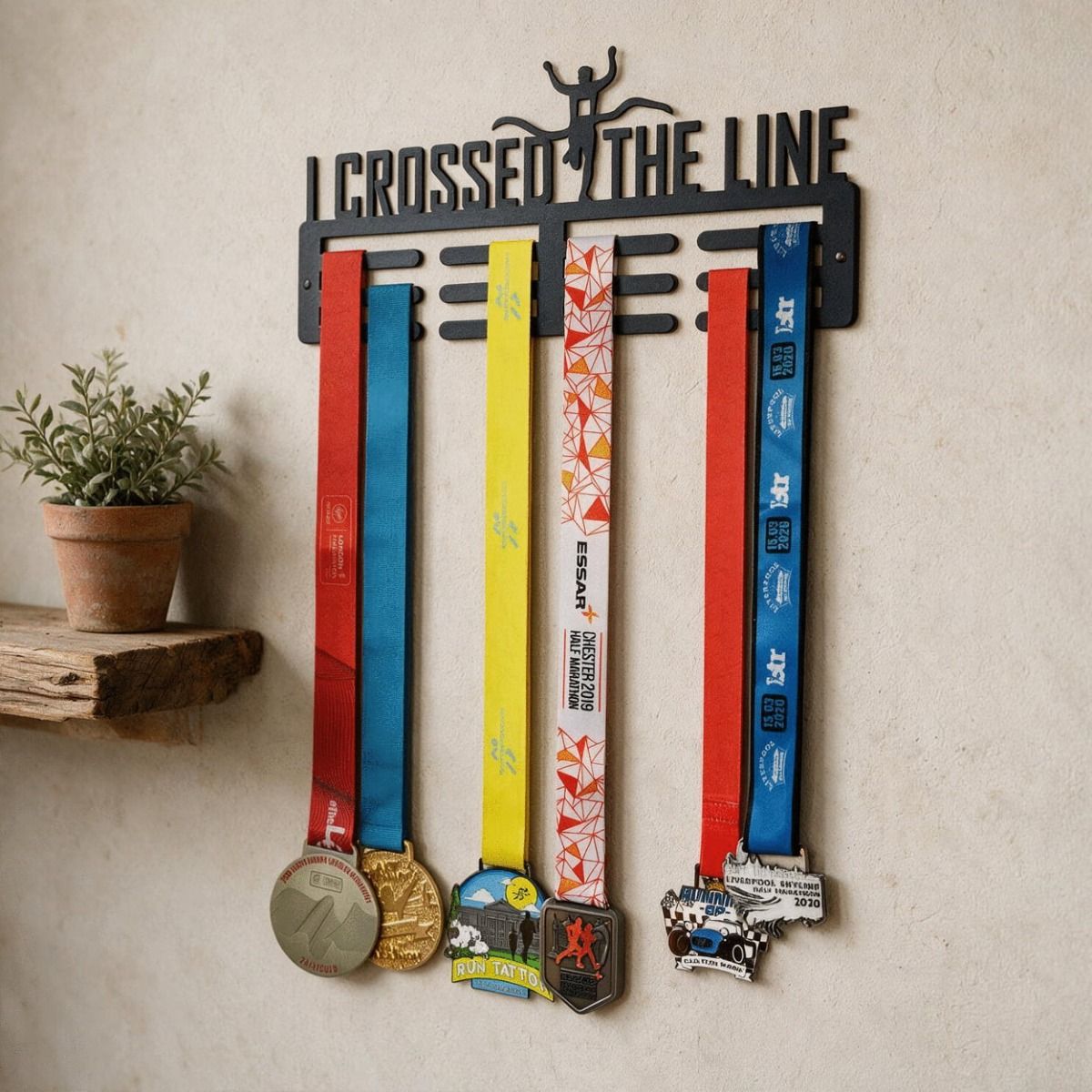The Male "I Crossed the Line" Sports Medal Hanger Displayed on a Magnolia Coloured Wall in a Country Home - Digital Illustration