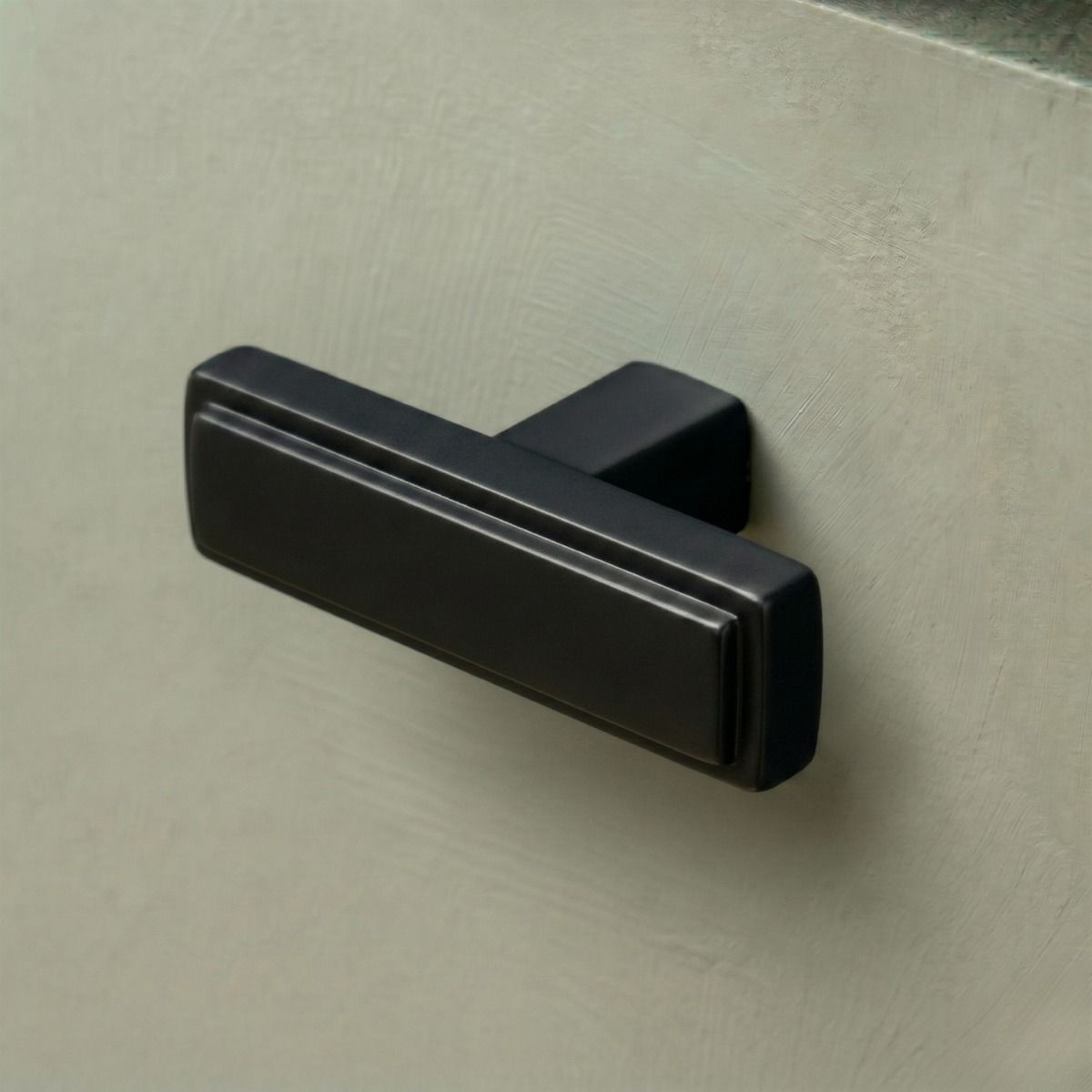 The Aged Brass "Emerson" Rectangular T-Bar Cabinet Pull Handle Mounted on a Wooden Kitchen Drawer - Digital Illustration 